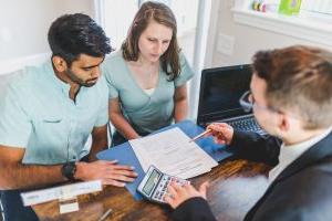 Sales representative looking over a document with a family